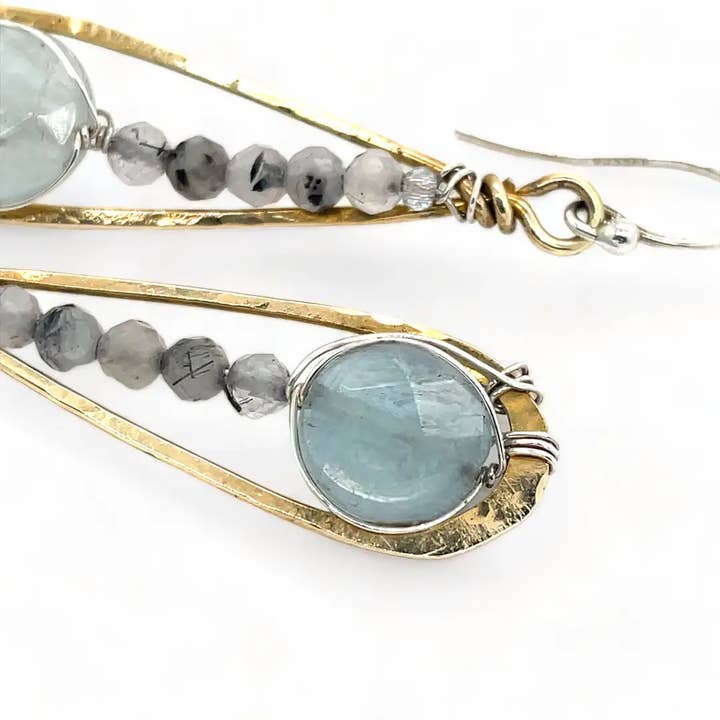 Gold and silver beaded earrings with gemstones on a white background