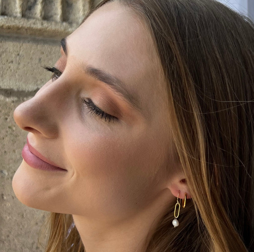 Close-up of a woman's profile with a stone wall background