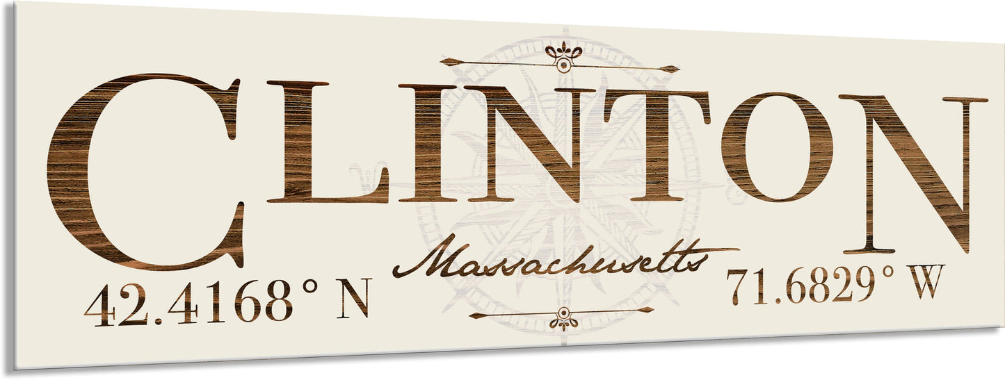 Decorative sign with 'Clinton, Massachusetts' and coordinates on a beige background
