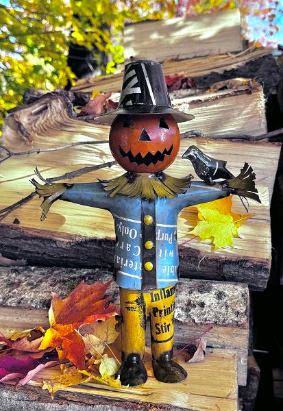 Halloween-themed scarecrow with pumpkin head and crow on a wooden background