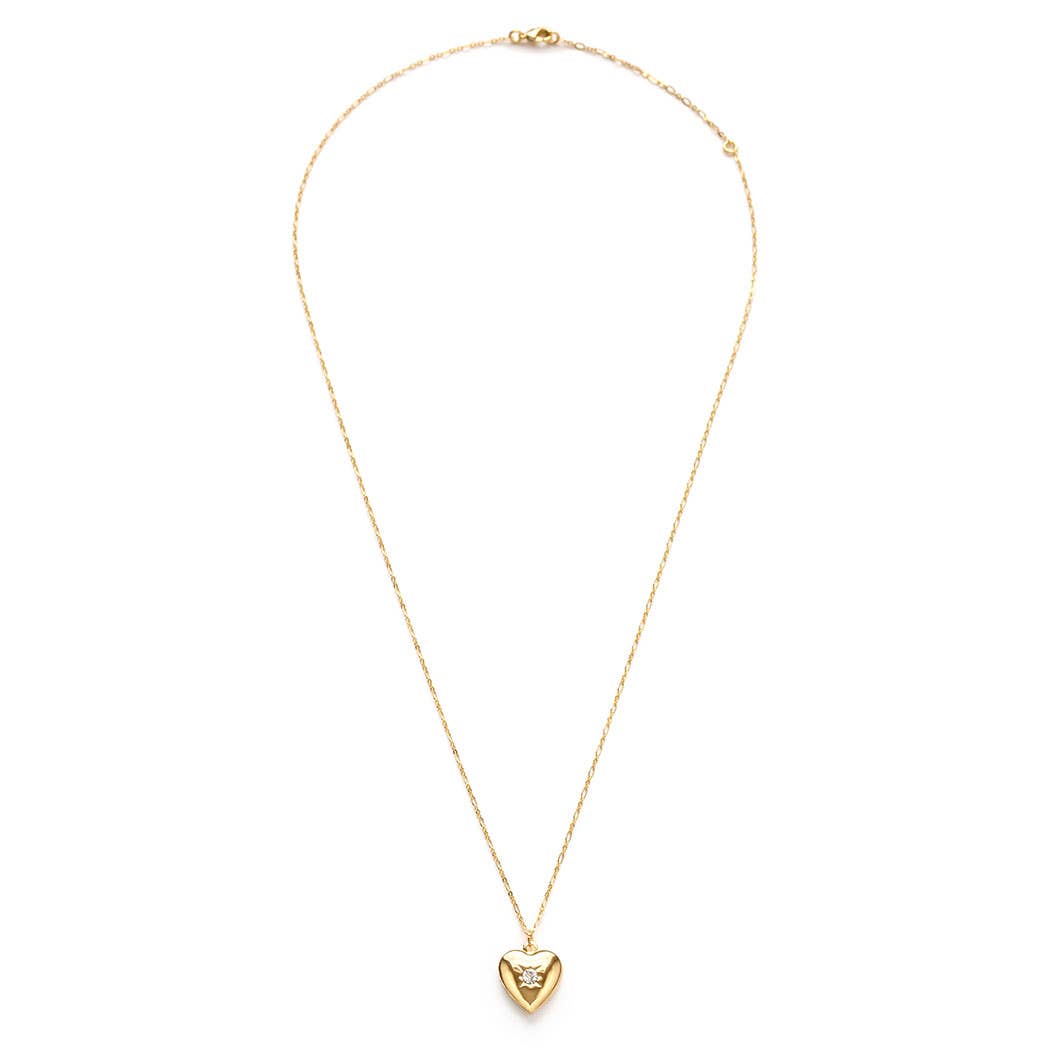 Gold necklace with a heart-shaped pendant on a white background