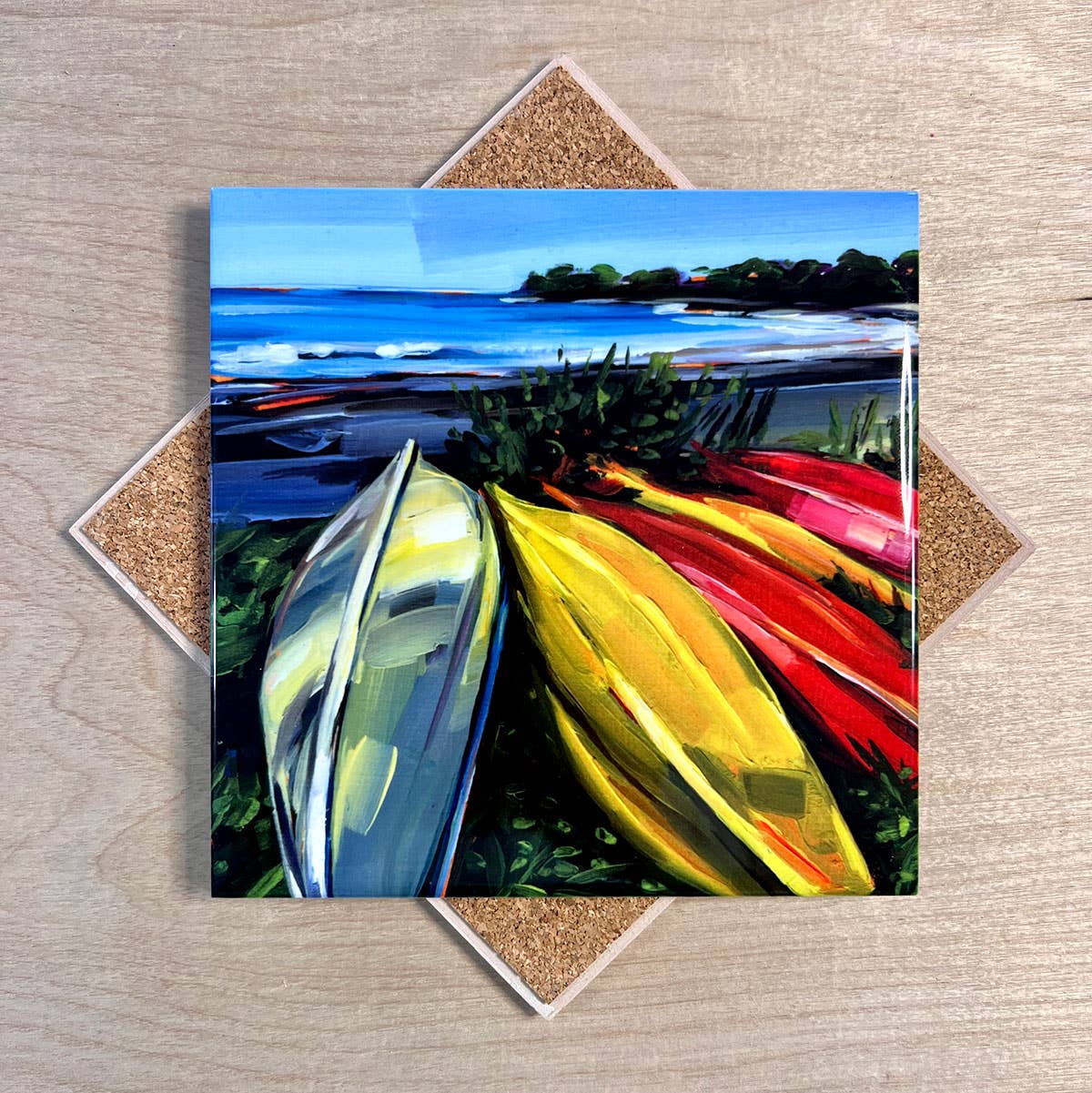 Colorful painting of kayaks on a wooden surface
