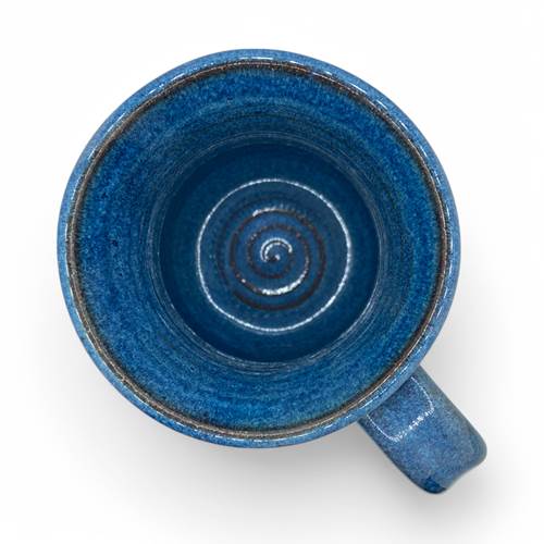 Blue ceramic mug with a spiral design on a white background