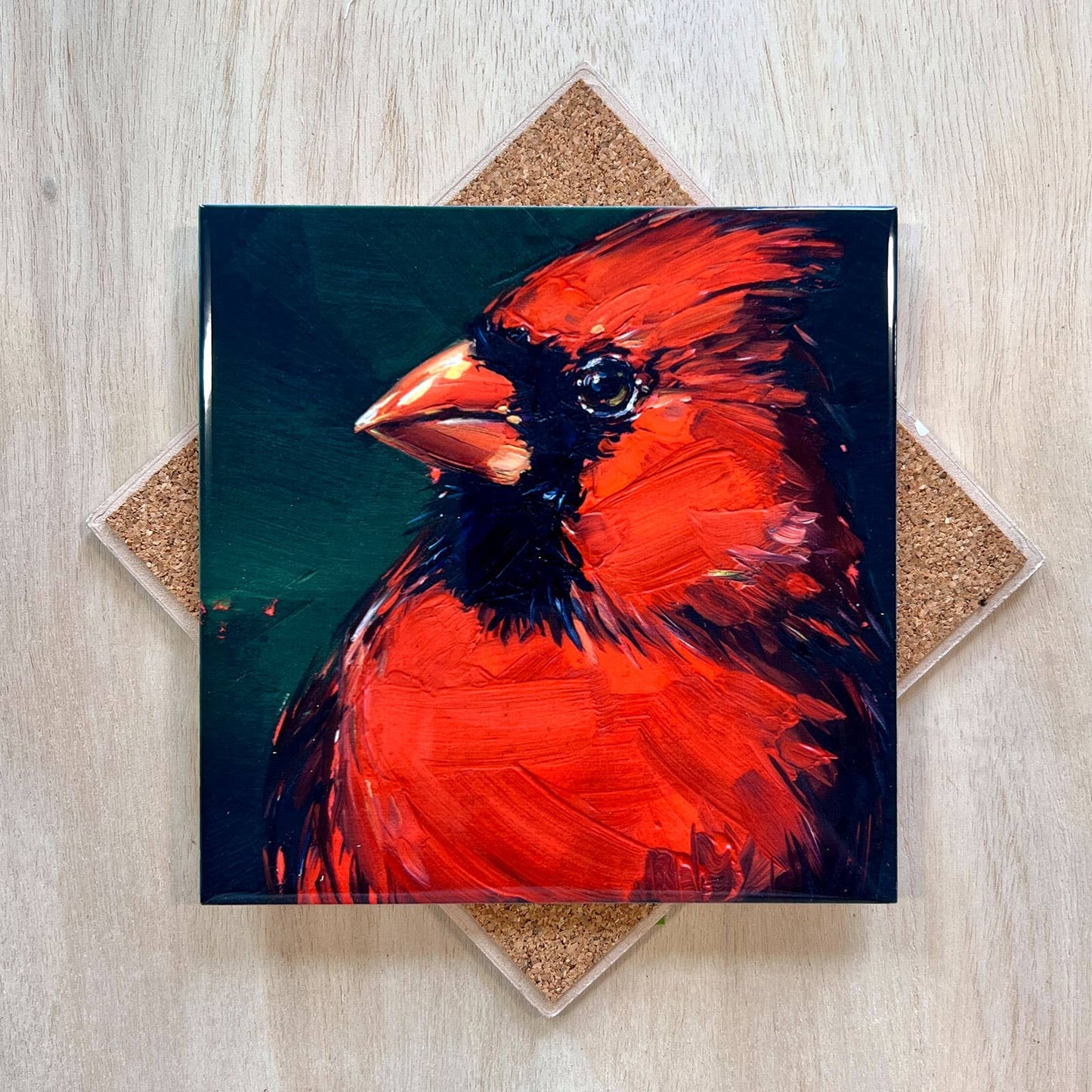 Painting of a red cardinal bird on a wooden surface