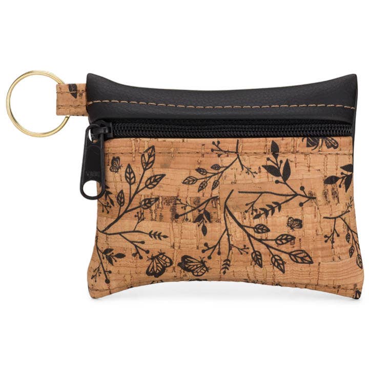 A small zippered pouch with a black floral cork pattern and a gold key ring attached to it
