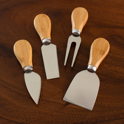 Set of four wooden-handled cheese tools on a wooden surface