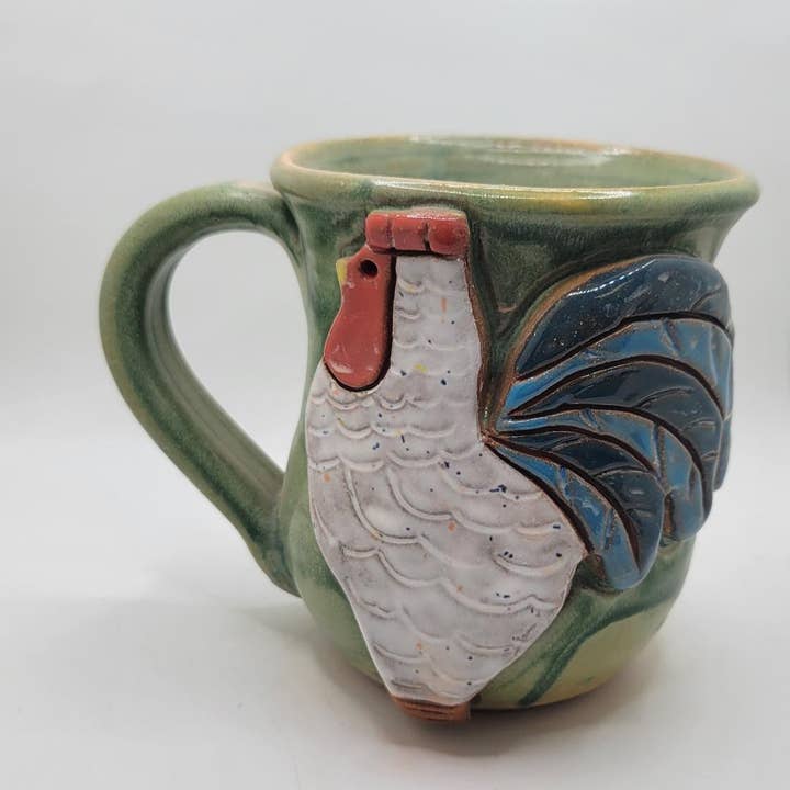 Ceramic mug with a rooster design on a white background