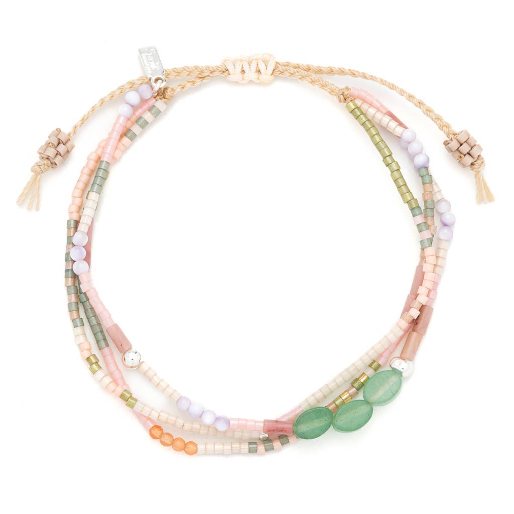 Bracelet with multiple strands of multicolored beads on a white background
