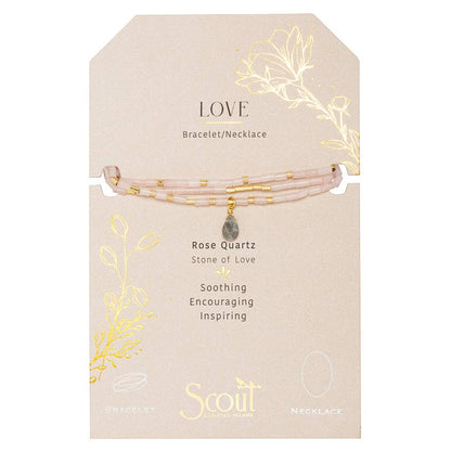 Rose Quartz bracelet on a beige card with gold leaf designs and Scout brand name.