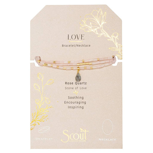 Rose Quartz bracelet on a beige card with gold leaf designs and Scout brand name.