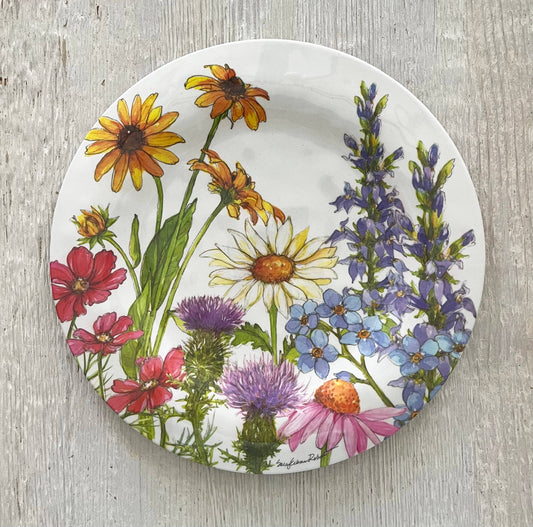 Round plate with colorful floral design on a wooden surface