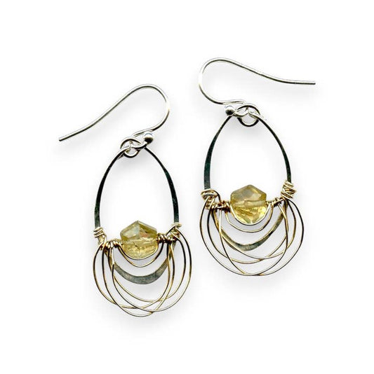 Pair of silver and gold hoop earrings with embedded stones on a white background