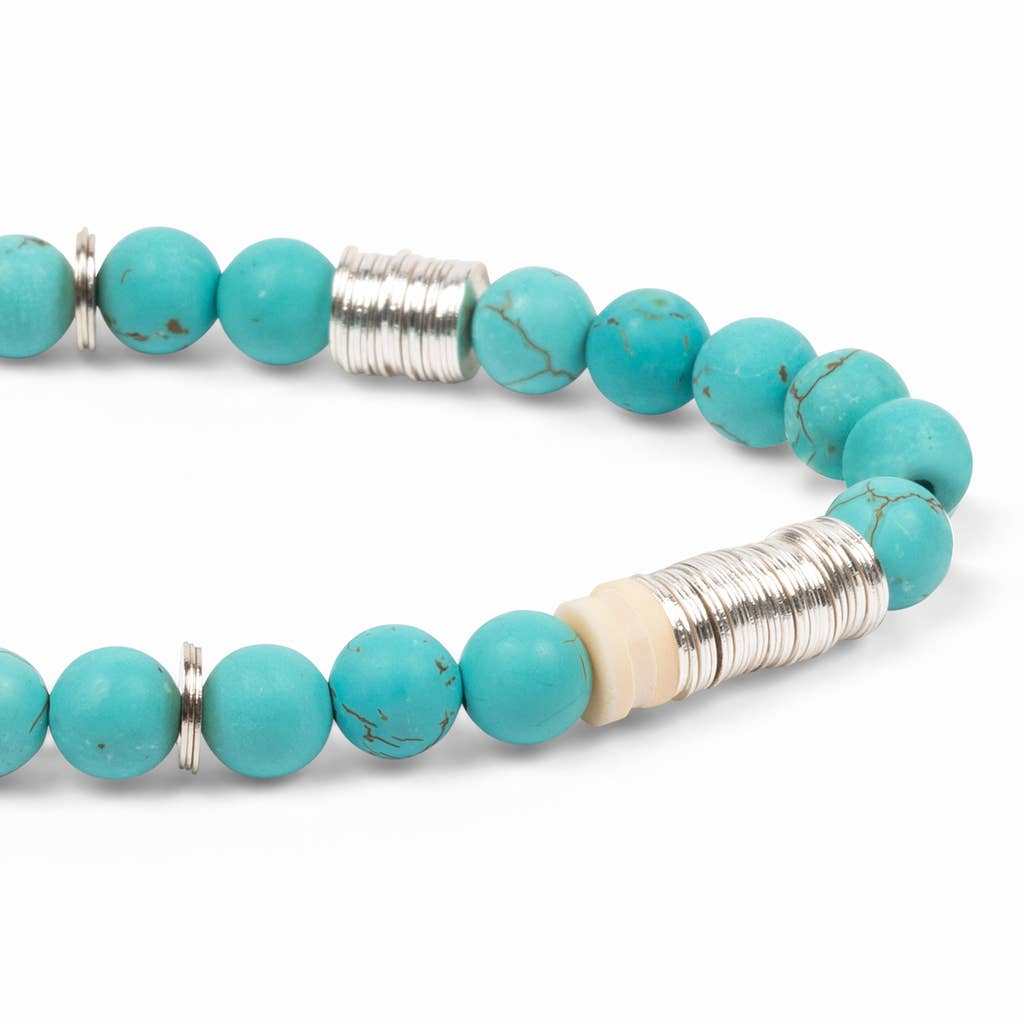Turquoise beaded bracelet with silver and gold accents on a white background
