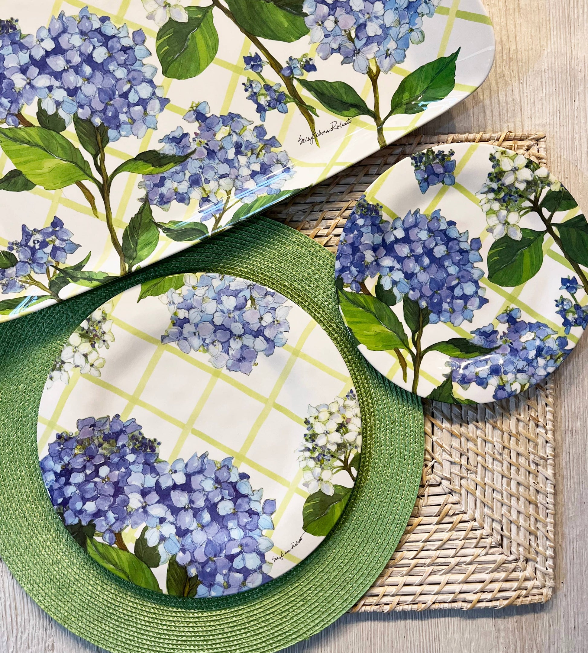 Tray and plates with blue hydrangea design on a woven placemat.