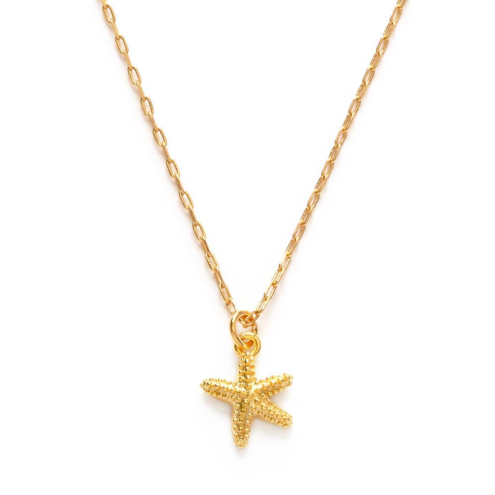 Gold starfish pendant necklace on a white background
