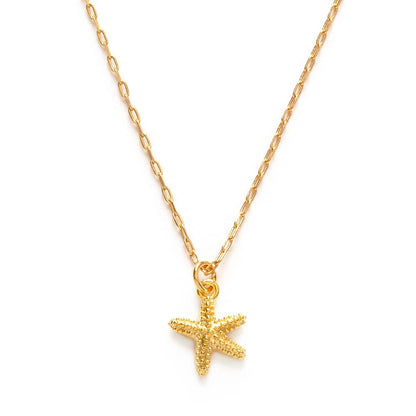 Gold starfish pendant necklace on a white background