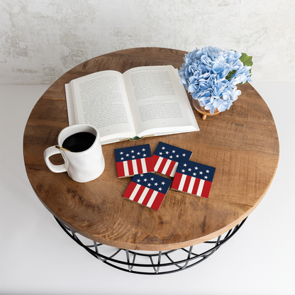Wooden table with a book, coffee cup, and American flag coasters.