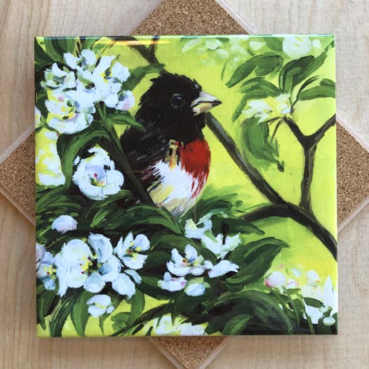 Trivet with a painting of a bird perched on a branch with white flowers and green leaves.