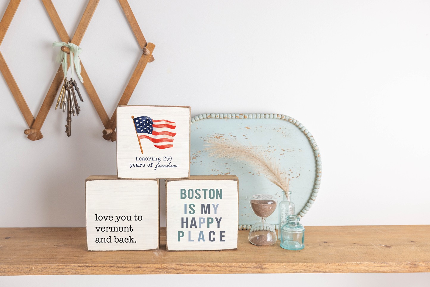 Decorative shelf with signs and a decorative plate on a white wall background