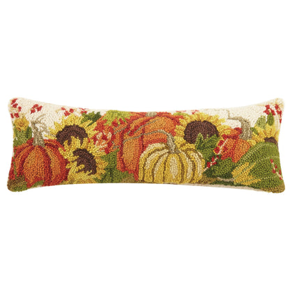 Decorative pillow with autumnal design featuring pumpkins and berries on a white background