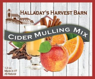 Halladay's Harvest Barn Cider Mulling Mix packaging with apples, oranges, and cinnamon sticks on a wooden background.