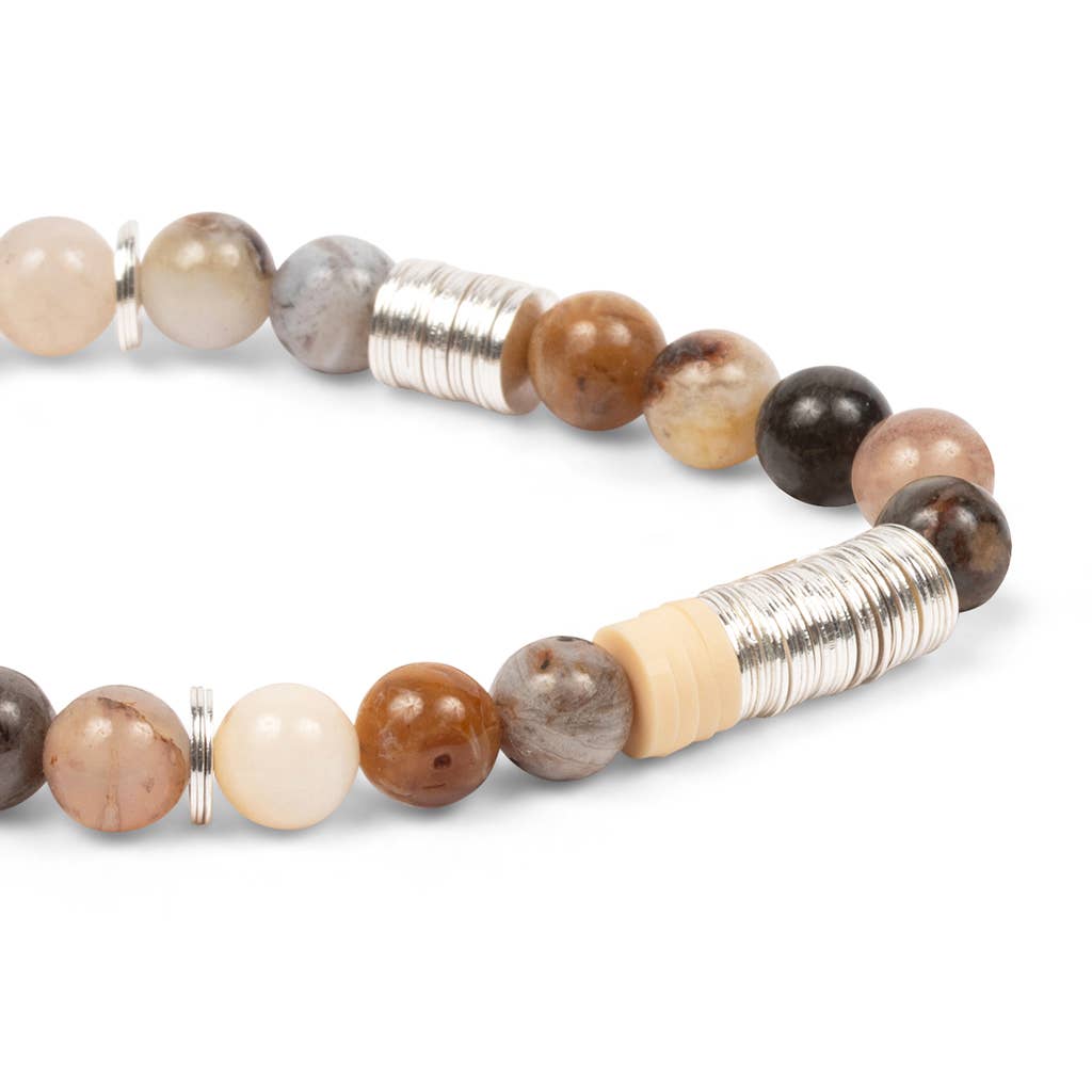 Beaded bracelet with natural stone beads and silver accents on a white background