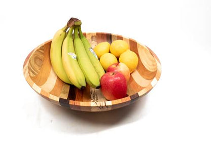 Wooden bowl with bananas, apples, and lemons on a white background