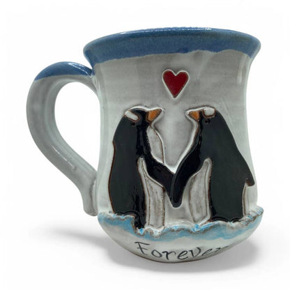 Ceramic mug with penguin design and 'Forever' text on a white background
