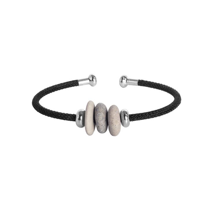 Bracelet with black cord and silver and stone beads on a white background