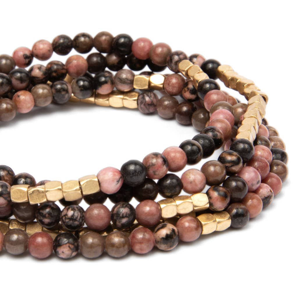 Convertible beaded necklace/wrap bracelet with gold accents on a white background