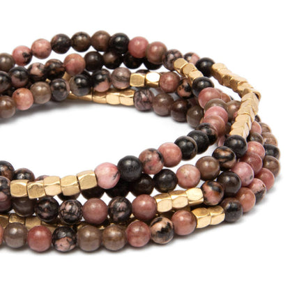 Convertible beaded necklace/wrap bracelet with gold accents on a white background