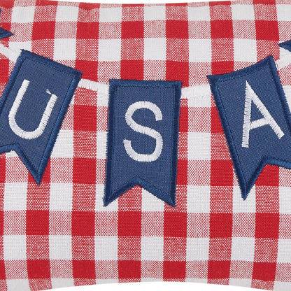 Pillow closeup with blue 'USA' banner patch on a red and white checkered fabric background