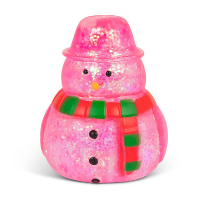 A small pink glittery snowman figurine with a matching glittery hat, a red and green striped scarf, and black button details, photographed on a clean white background.