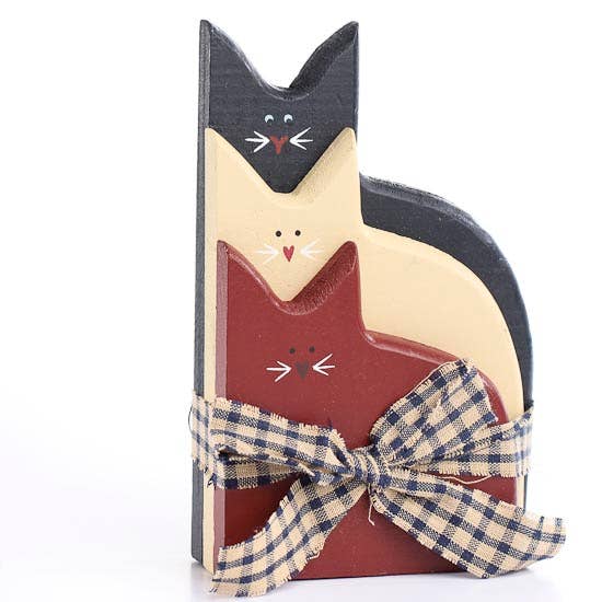 Wooden cat-shaped decoration with a plaid bow on a white background