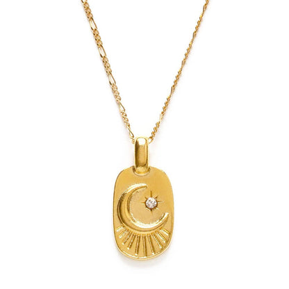 Gold necklace with a crescent moon pendant on a white background
