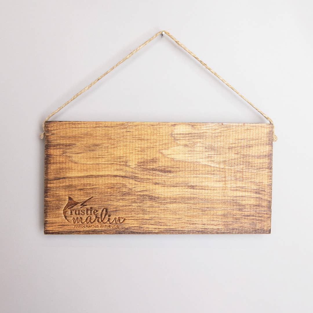 Wooden sign with 'Rustic Marlin' branding on a light gray background