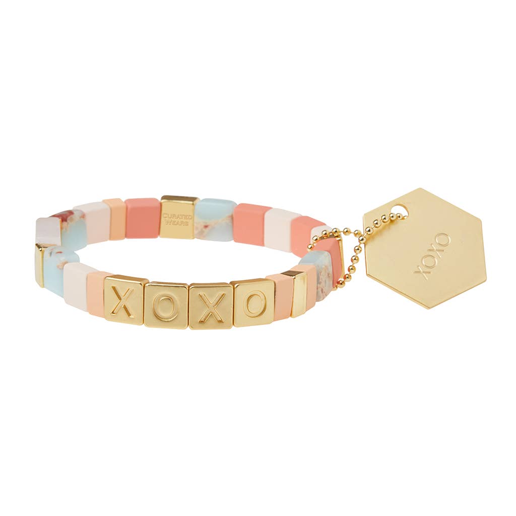 Bracelet with colorful beads and gold accents on a white background