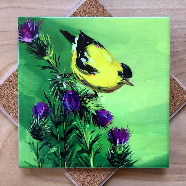 Trivet with a painting of a yellow bird on a green background with purple flowers