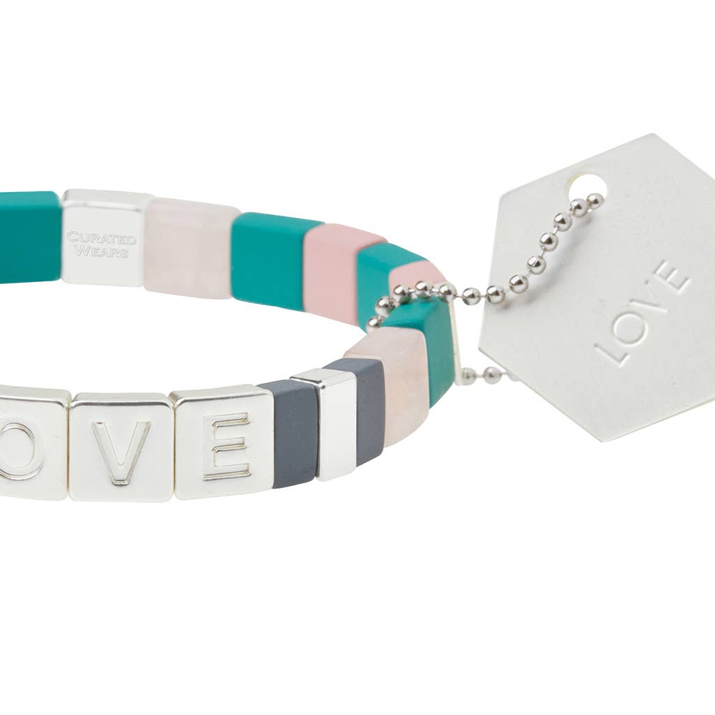 Colorful bracelet with 'LOVE' tag on a white background