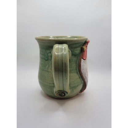Green ceramic mug with a handle on a white background