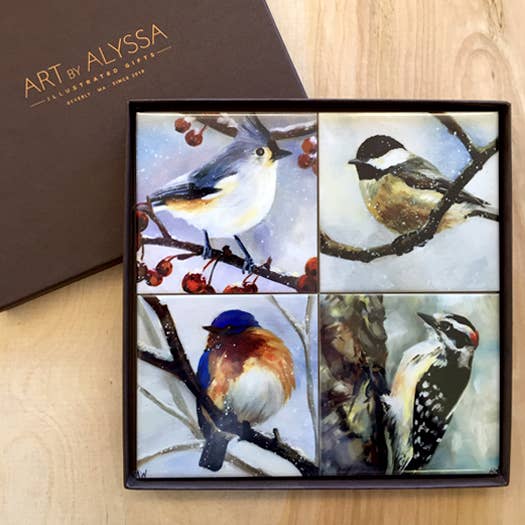 Set of four coasters with bird illustrations in a gift box with 'Art by Alyssa' branding.