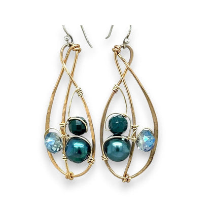 Gold-framed earrings with blue beads on a white background