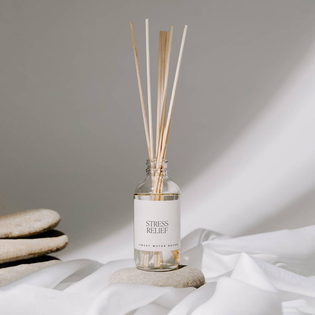 Reed diffuser labeled 'Stress Relief' on a neutral background.