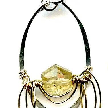 Earrings with a yellow gemstone and wirework on a white background