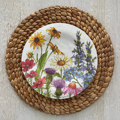 Round plate with floral design on a woven placemat