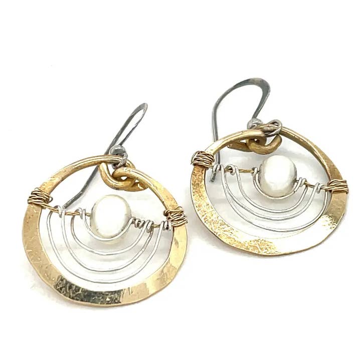 Pair of gold and silver earrings on a white background