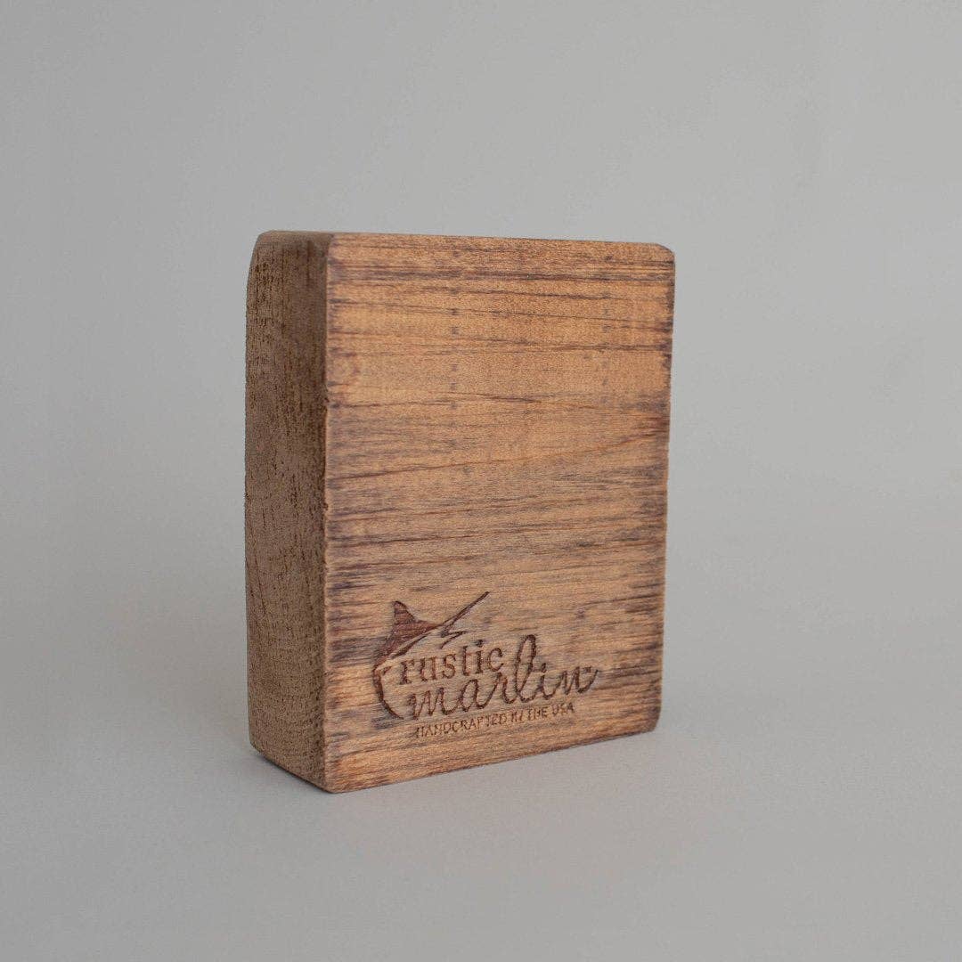Wooden block with 'Rustic Marlin' branding on a gray background