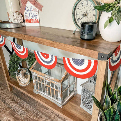 Wooden console table with American flag decorations and a clock in the background.