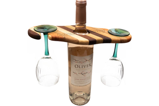 Wooden wine caddy in use with a wine bottle and two stemmed wine glasses.
