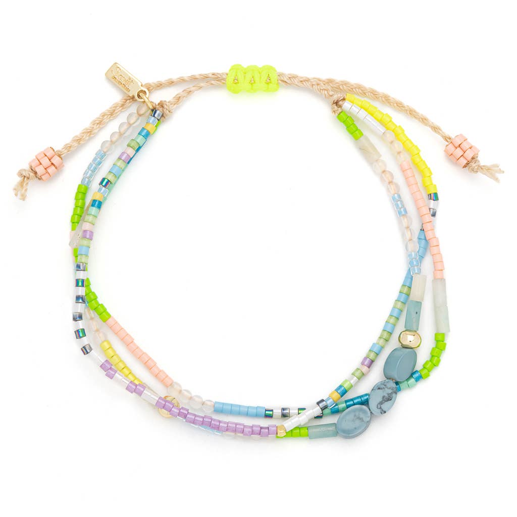 Set of colorful beaded bracelets on a white background